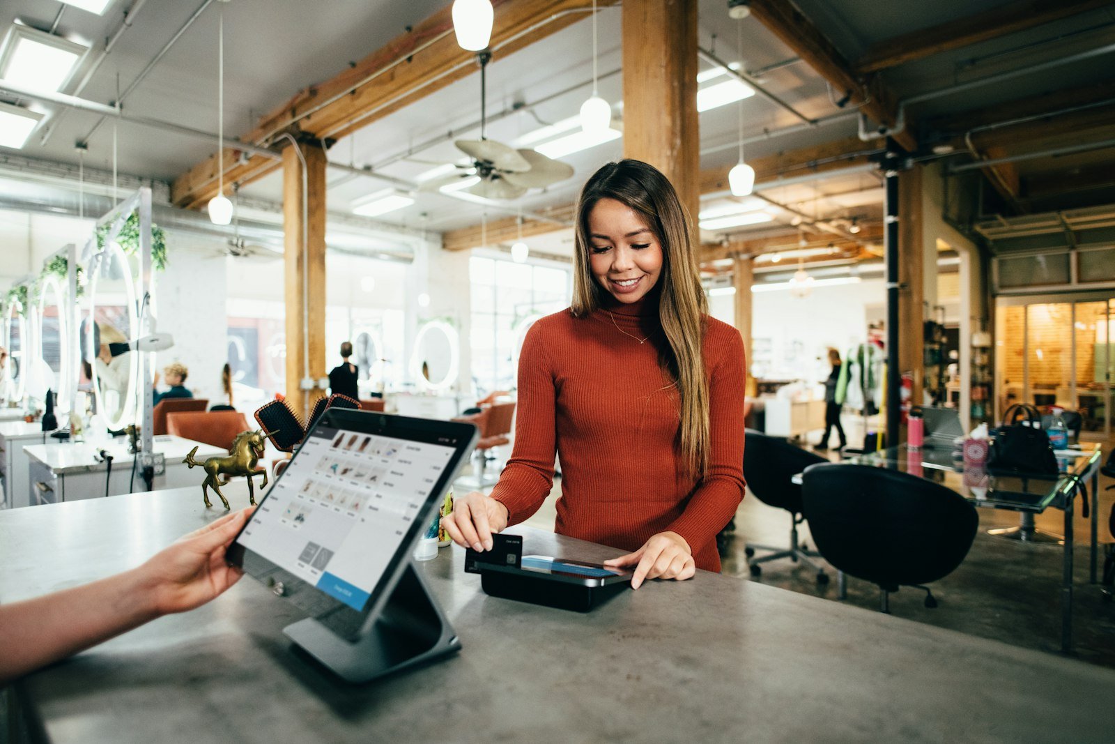 Small business owner at the counter of their shop